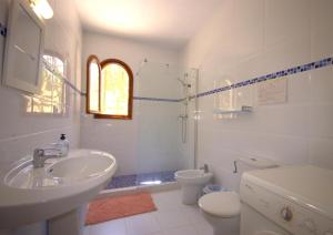 ein weißes Badezimmer mit Waschbecken und Toilette in der Unterkunft Holiday Home La Cartuja in Jávea