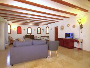 a living room with a couch and a tv at Holiday Home La Cartuja in Jávea