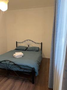 a bedroom with a bed with two towels on it at Уютная квартира in Almaty