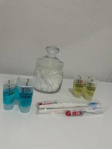 a shelf with toothbrushes and a jar of toothpaste at Уютная квартира in Almaty