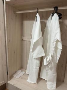 two white towels are hanging on a rack in a shower at Уютная квартира in Almaty