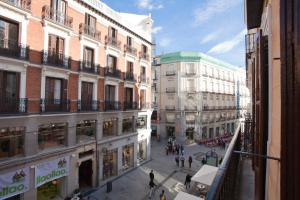 a city street with buildings and people walking around at Suites You Nickel in Madrid