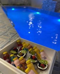 a drawer filled with food next to a swimming pool at أستراحة السعادة in Jalan Bani Buhassan