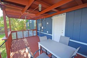 a patio with a table and chairs on a deck at Home Sweet Home - Peace, Love, & Enjoy in Kingsville
