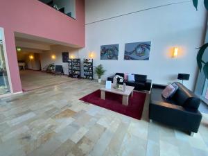 a living room with a couch and a table at Seehotel in Kell +44 photos