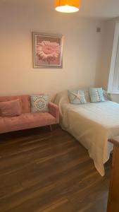 a living room with two beds and a couch at Bexhill Stunning 2 bedroom Sea Front Bungalow in Bexhill