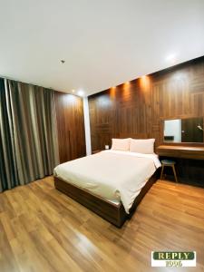 a bedroom with a large bed and a desk at DaLat Center Apartment in Da Lat