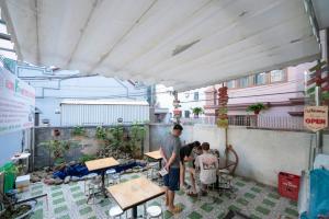 a group of people standing in a room with tables at Fancy Hostel and Bar in Ha Long