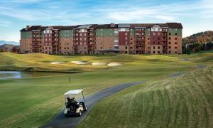 a golf cart driving down a road in front of a building at Great Smokies Lodge Resort 2BR in Sevierville