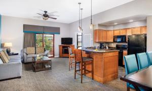 a kitchen and living room with a couch and a table at Great Smokies Lodge Resort 2BR in Sevierville