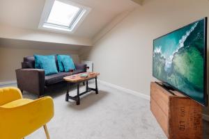 a living room with a couch and a flat screen tv at Albert Road Apartments Flat 3 in Colne