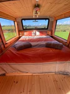 A bed or beds in a room at Sleeps 6/bus/hottub/sauna/Pets/Hens