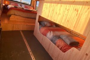 a room with two bunk beds in a cabin at Sleeps 6/bus/hottub/sauna/Pets/Hens in Irvinestown