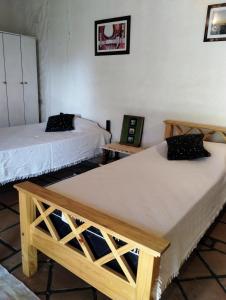 Casa La Banda في كفايات: سريرين في غرفة بطاولتين