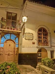a building with two doors and a sign on it at Hatuchay Inka Apart Hotel in Cajamarca