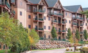 a large apartment building with a road in front of it at Wyndham Glacier Canyon 2 BR in Baraboo
