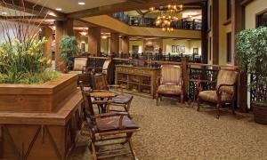 a lobby with a bar and chairs and a restaurant at Wyndham Glacier Canyon 2 BR in Baraboo