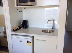 a kitchen counter with a microwave and a dishwasher at PA Apartments in Brisbane