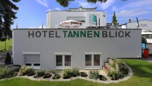 a white building with a sign that reads hotel tammen blck at Hotel Tannenblick in Bad Vilbel