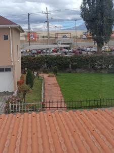 a view of a yard with a parking lot at Orange Blossom in Riobamba