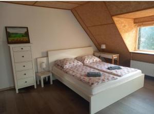 a bedroom with a white bed and a window at Ranczo u Andrzeja in Rybaki