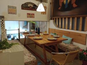 a dining room with a wooden table and chairs at Hatuchay Inka Apart Hotel in Cajamarca