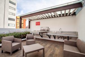 a patio with a sink and two chairs at Corazón de Condesa 3 departamentos - 200Mbps WiFi, Roof, Gym in Mexico City