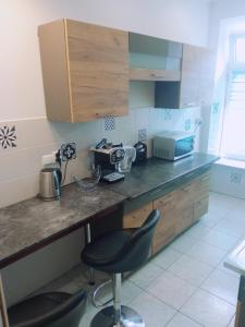a kitchen with a counter and a chair in it at Rafaelo Władycze 17/4 in Przemyśl