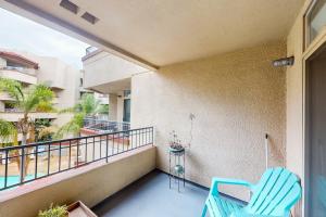 a balcony with two blue chairs on a building at San Diego's Diamond in San Diego