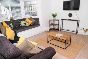 a living room with a couch and a coffee table at Garden of Eden 1 Bedroom Flat in Fishponds in Bristol