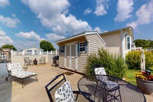 a patio with chairs and a tiny house at Bay-View Beauty in Assateague Point in Berlin