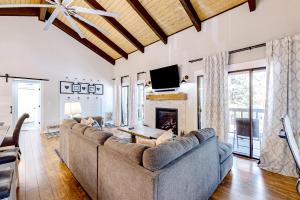 a living room with a couch and a fireplace at Sway of the Pines, Unit#32A in Indian Pine