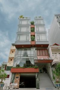 a tall building with stairs in front of it at Bel-Air Hotel in Quy Nhon