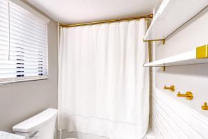 a bathroom with a shower curtain and a toilet at Sway of the Pines, Unit#32A in Indian Pine +17 photos