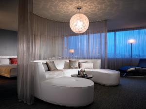 a living room with a white couch and a table at W Hollywood in Los Angeles