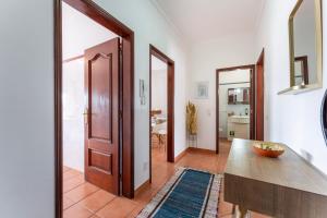 a hallway with a door leading to a kitchen at Peaceful 1 BDR Apartment W/ Balcony by LovelyStay in Almancil