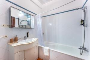 a bathroom with a tub and a sink and a shower at Peaceful 1 BDR Apartment W/ Balcony by LovelyStay in Almancil