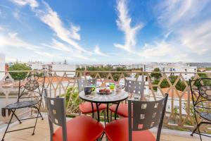 a balcony with a table and chairs with a view at Peaceful 1 BDR Apartment W/ Balcony by LovelyStay in Almancil