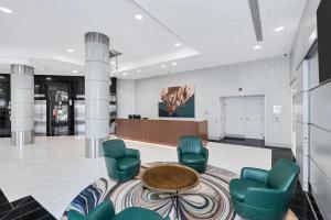 a lobby with chairs and a table and a stage at Stylish and charming Apartment in Pentagon City in Arlington