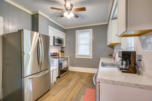 a kitchen with a stainless steel refrigerator and white cabinets at Downtown Wilmington Studio - Pets Welcome! in Wilmington