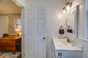 a white bathroom with a sink and a mirror at Downtown Wilmington Studio - Pets Welcome! in Wilmington +16 photos