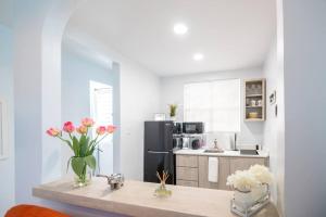 a kitchen with a counter with vases of flowers on it at 1 Santurce 1 Bedroom 1Bathroom Apt in San Juan