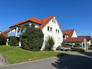 a large white house with a red roof at Ferienwohnung in Buchen - Pure Entspannung im Odenwald in Buchen