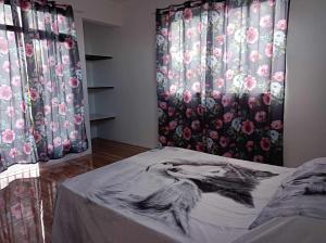 a bedroom with curtains with a drawing of a bird at Villas Andrez in Savinia