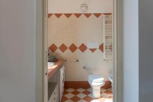 a bathroom with a toilet and a sink at Sweet home Suite - Duomo, Milano in Milan