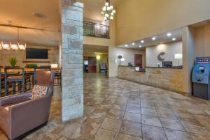 a lobby of a hotel with a bar and a restaurant at Comfort Suites Arlington - Entertainment District in Arlington