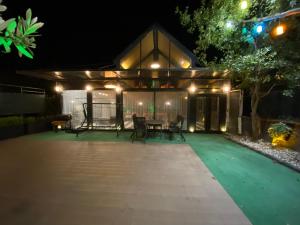 a patio at night with a table and chairs at Villa Peri room room in Sapanca