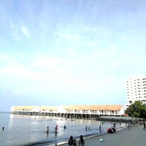 a group of people in the water near a pier at Le Seaview PortDickson in Port Dickson