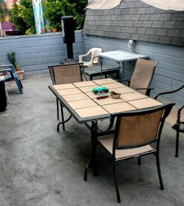 a wooden table and chairs on a patio at Los Angeles Zen Home in Los Angeles