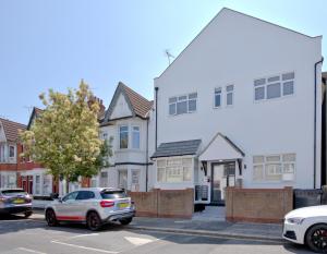 a row of houses on a street with parked cars at K Suites - Westborough Road in Southend-on-Sea